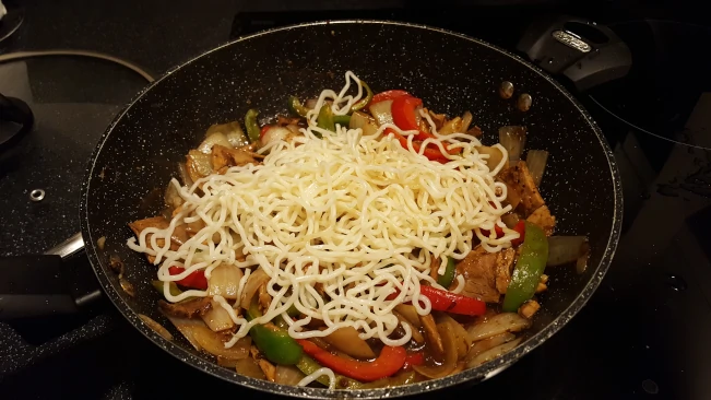 noodles added to pork and blackbean