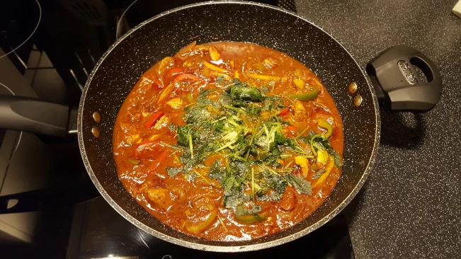 coriander added to pork madras coriander added to pan