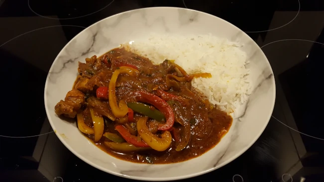 pork madras curry finished in a pan pork madras and basmati rice