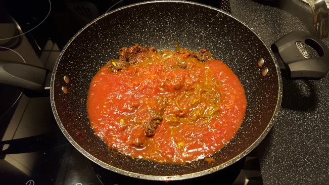 diced pork for pork madras tomatoes added to paste