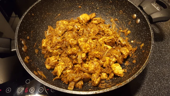 pork onions and spices mixed in the pan