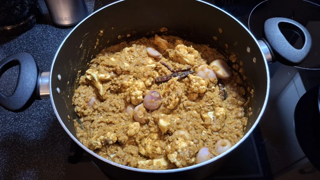 sambar stirred to coat vegetables sambar stirred