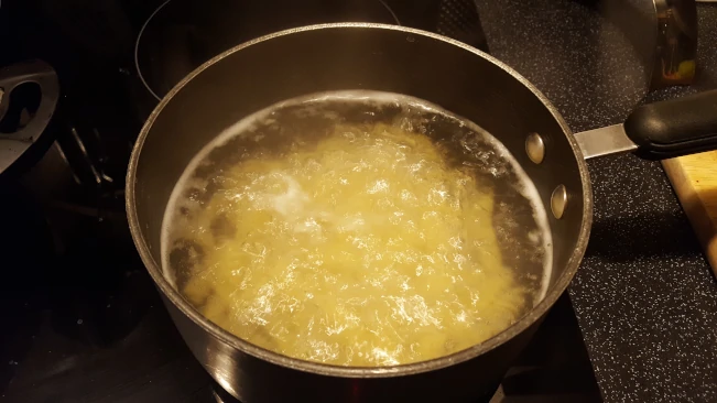 fusilli pasta boiling in pan
