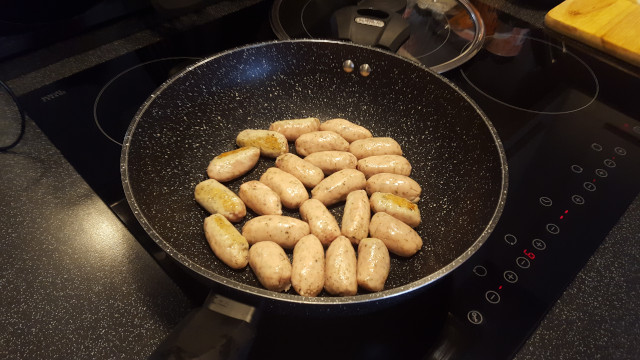 sausage browning in a pan