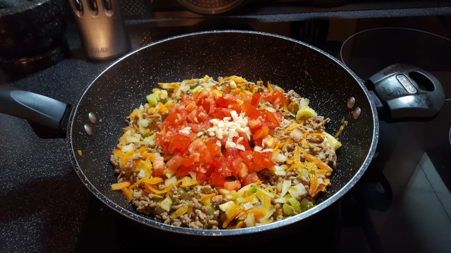 tomatoes and garlic added to savoury mince tomatoes and garlic added