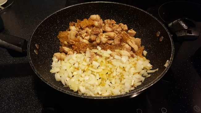 onions added to rice and chicken