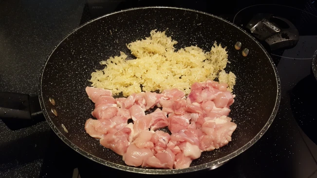raw rice and chicken frying