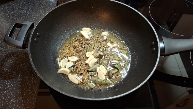 garlic added to frying seeds for spicy balti potatoes garlic added to frying seeds