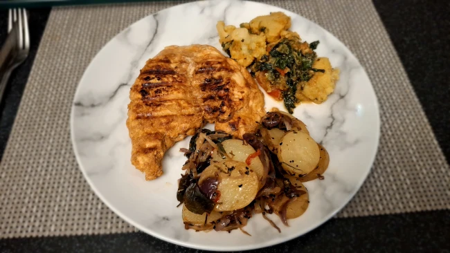 indian dinner on a plate with spicy balti potatoes indian dinner on a plate