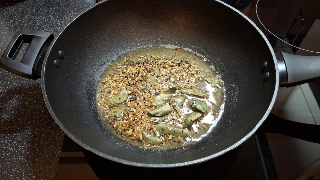 seeds and leaves frying for spicy balti potatoes seeds and leaves frying