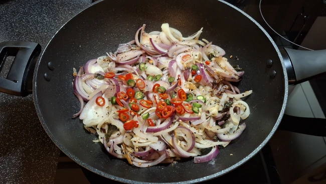 onion chillies seeds frying for spicy balti potatoes onion chillies seeds frying