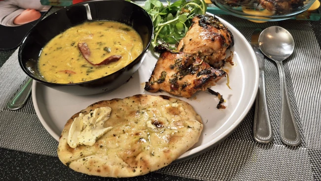 spicy masala chicken tarka dhal naan plated