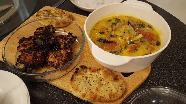 spicy masala chicken tarka dhal naan plated