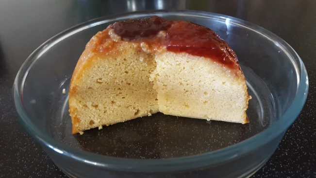 sliced steamed sponge pudding with a strawberry jam topping steamed pudding sliced