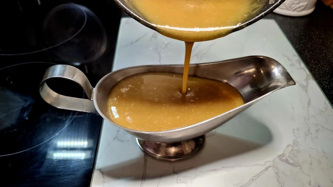 caramel sauce being pured into a sauce boat