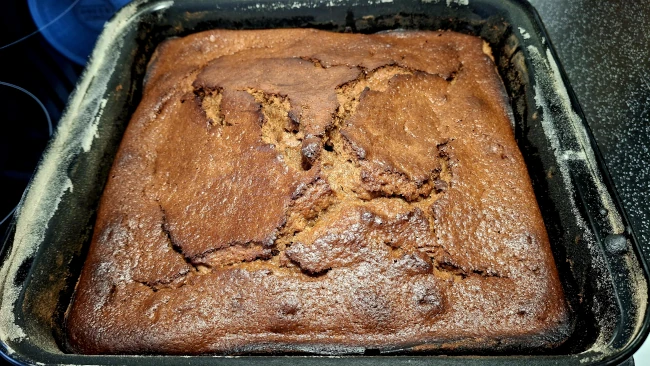 cooked sticky toffee pudding in a baking tray