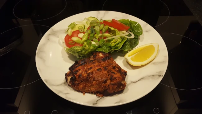 tandoori chicken and salad plated