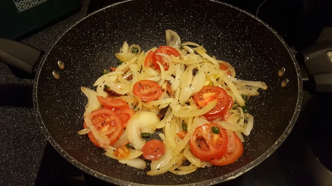 tomatoes added to pan for tarka dhal tomatoes added