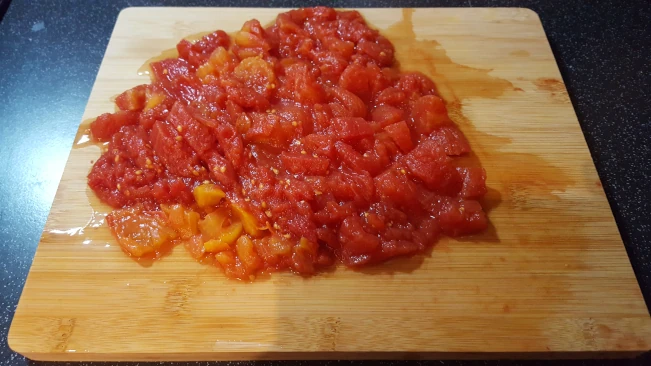 chopped tomatoes on a board for tomato chutney chopped tomatoes on a board